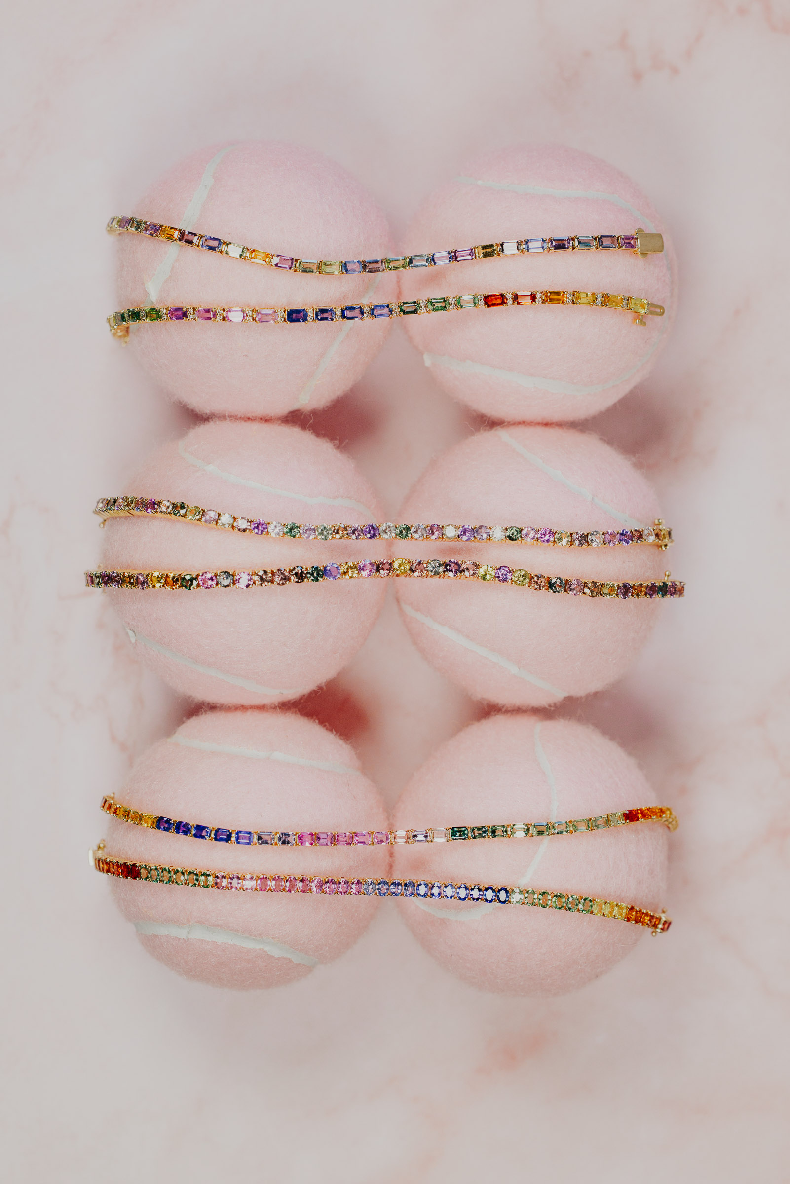 Rainbow Tennis bracelets on pink tennis balls.