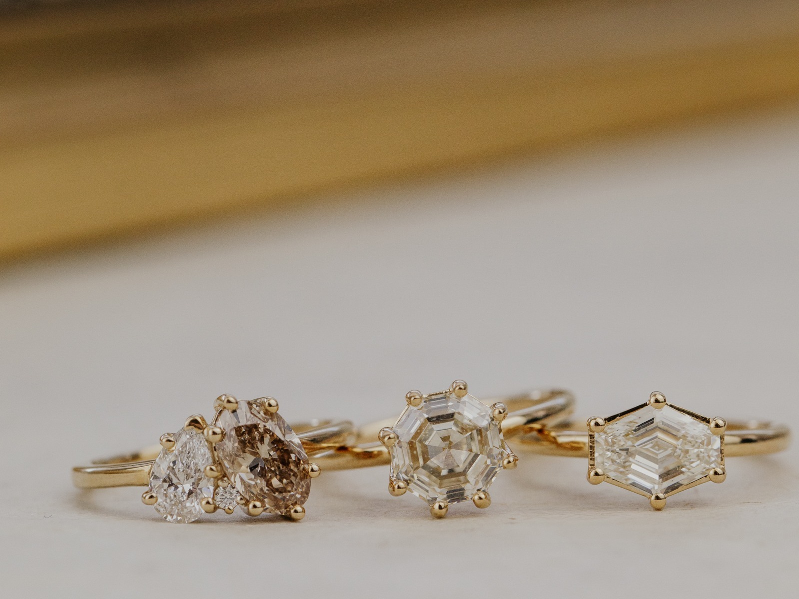 Three Champagne diamonds in different shapes and colors on a white background.