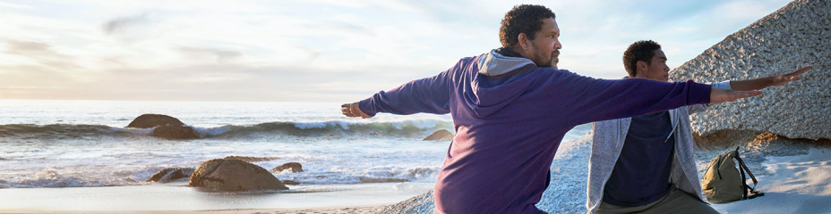 Man and young adult practicing yoga