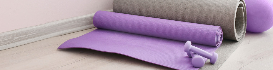 purple yoga mats and a pair of weights