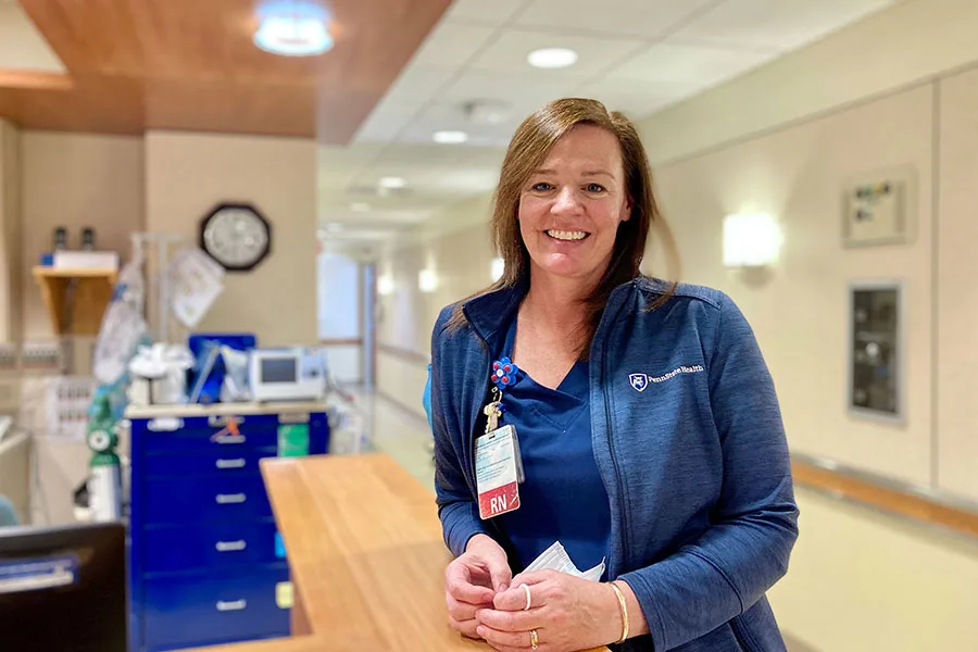 Person standing at a reception desk. 