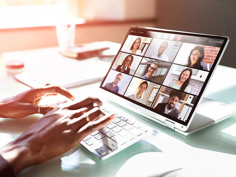laptop screen with multiple video callers displayed.