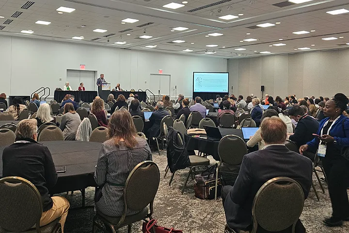 Dale Fallon speaking to a full room alongside Lauren Van Scoy and Sarah Horvath during their presentation
