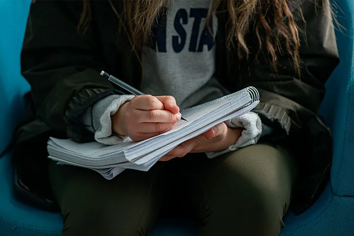 A student writing in a notebook