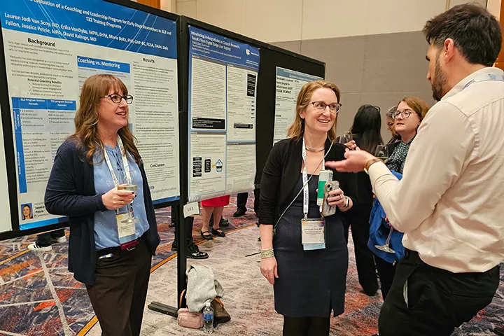 Jess Petrie, Lauren Van Scoy, and Jamal Essayli stand by TS26 poster