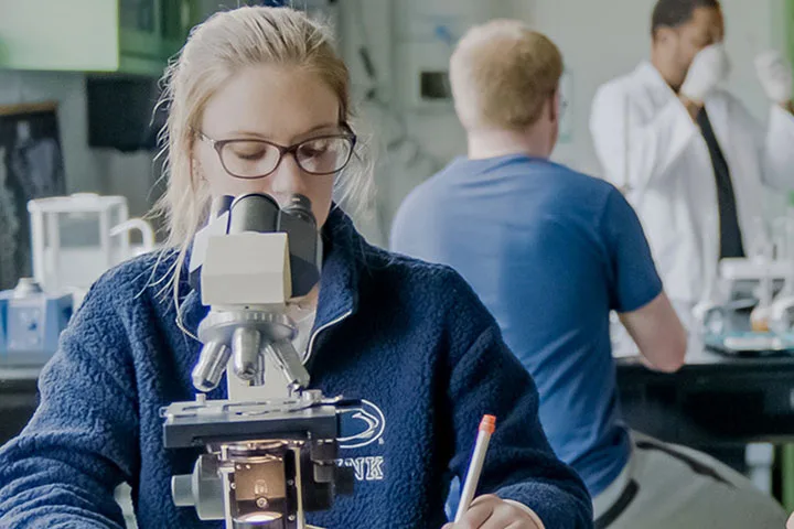 Student working at a microscope