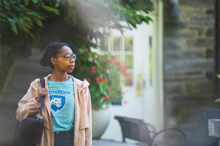 Student walking on Penn State campus