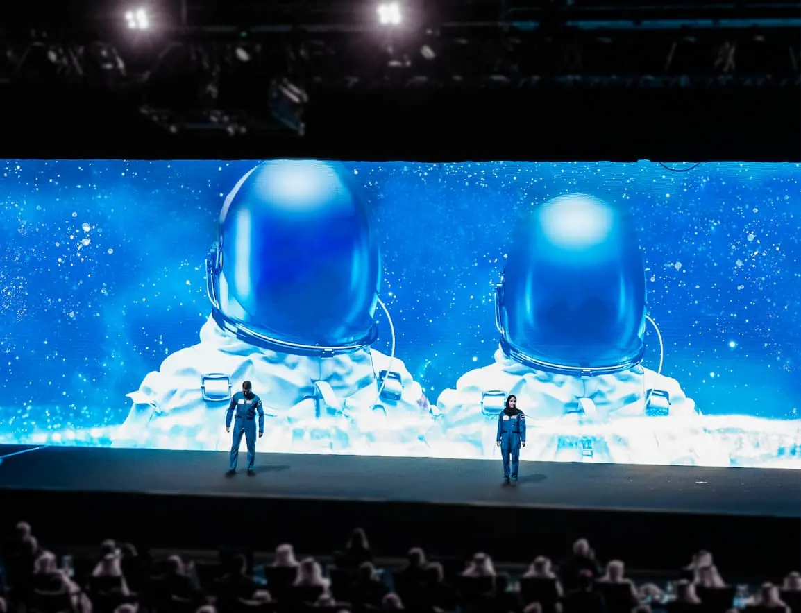 Two astronauts standing on the main stage of IAC 2021