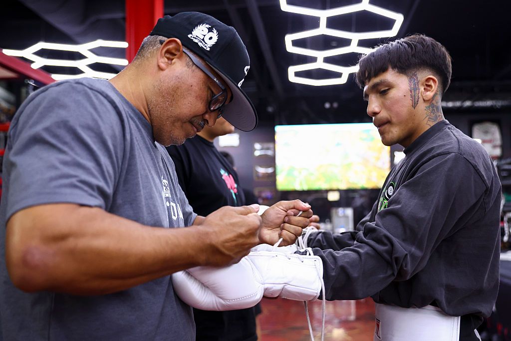 Robert Garcia wrapping Jesse Bam Rodriguez's hands at a boxing gym
