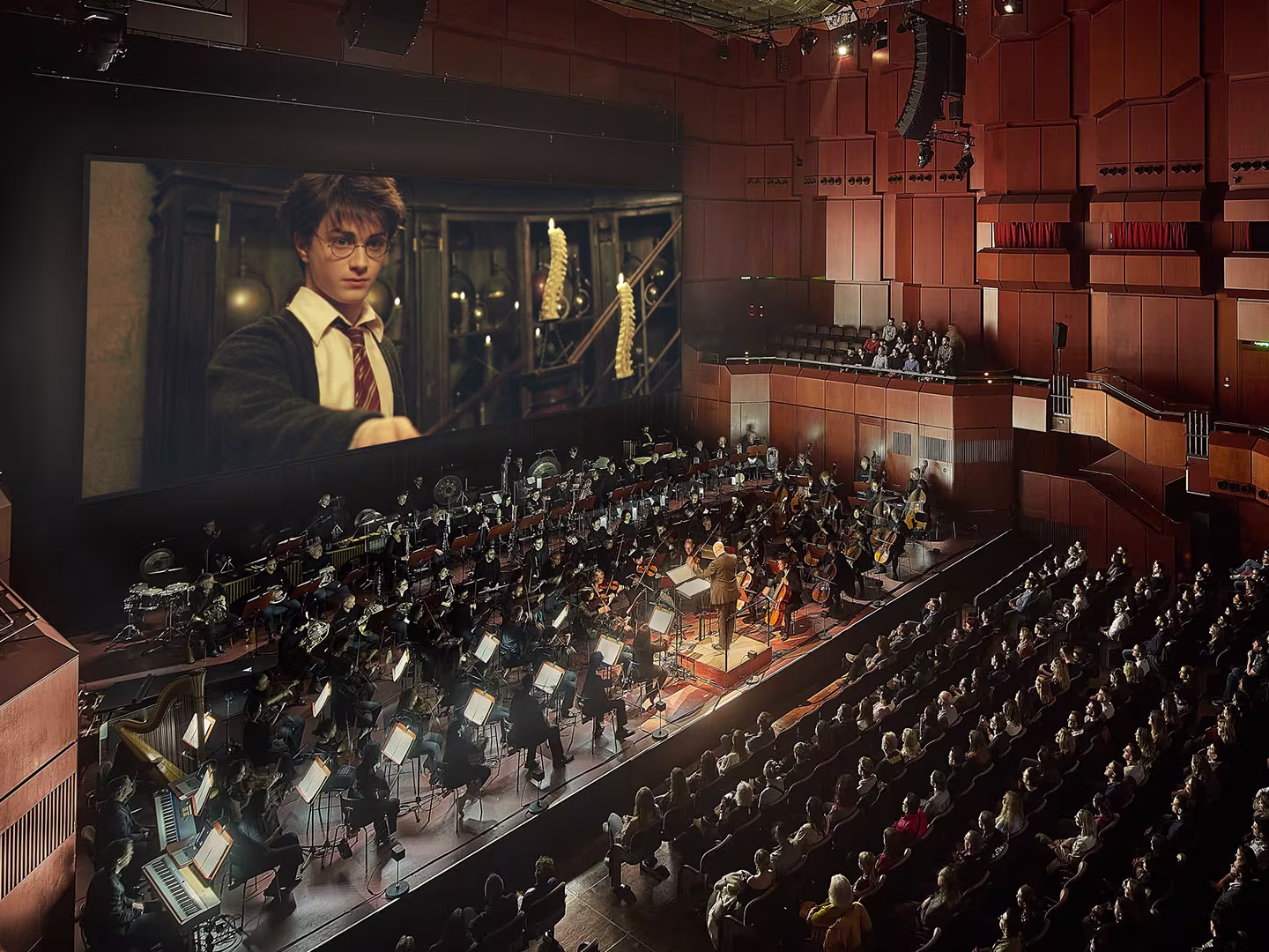Einblicke in die Show "Harry Potter und der Gefangene von Askaban". Auf der Bühne ein Orchester welches den Film auf der Leinwand begleitet.
