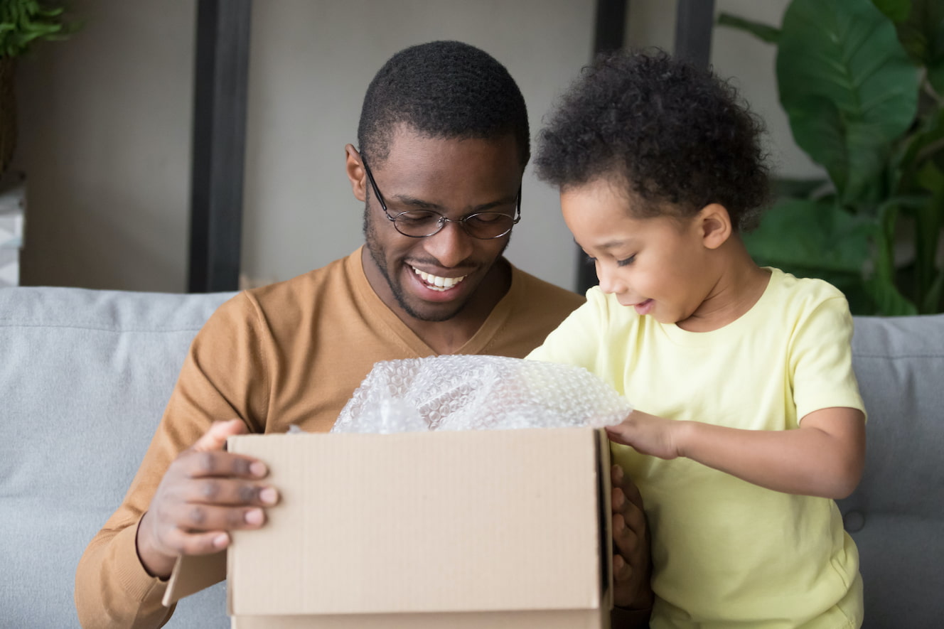 Man opening package with child