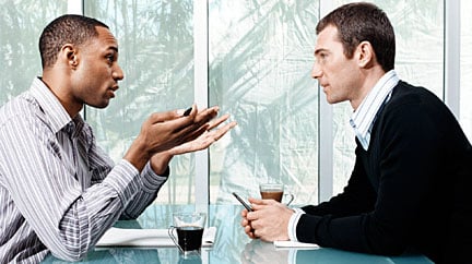 Two men discussing something serious