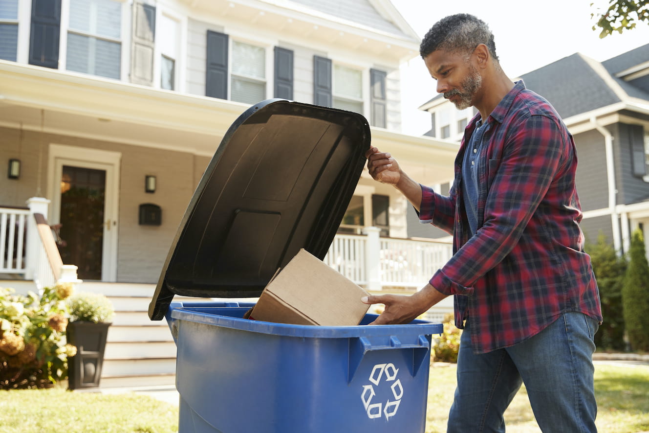 Man throwing away box