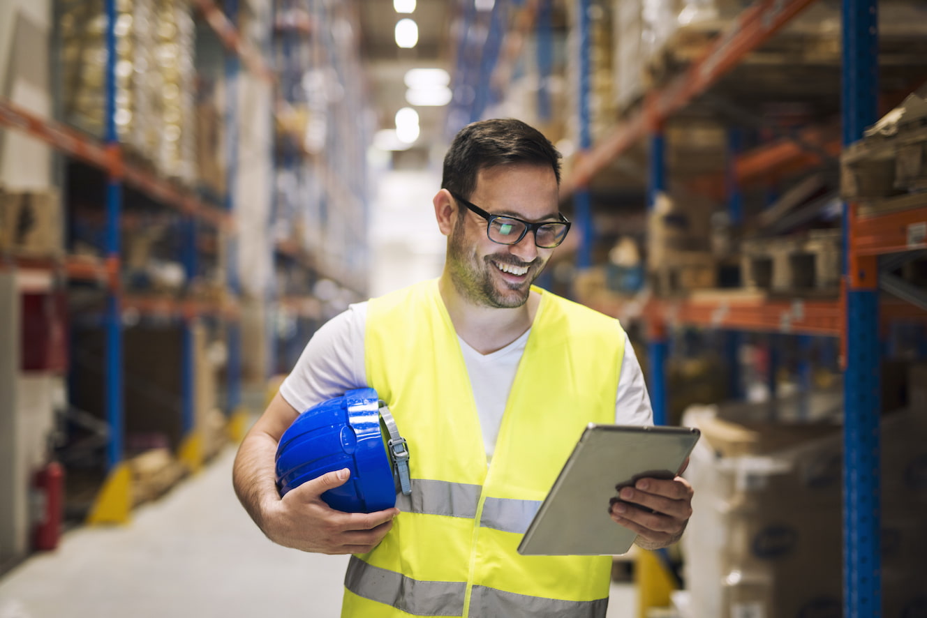 Man looking at tablet in a warehouse