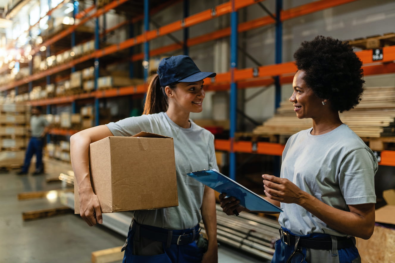 Two people talking in a warehouse