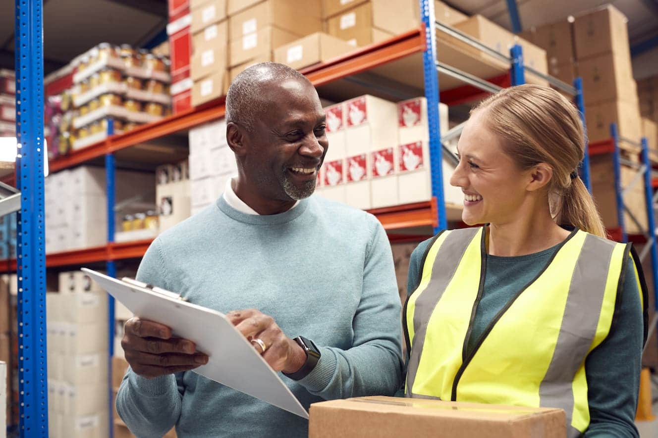 man and woman talking in warehouse