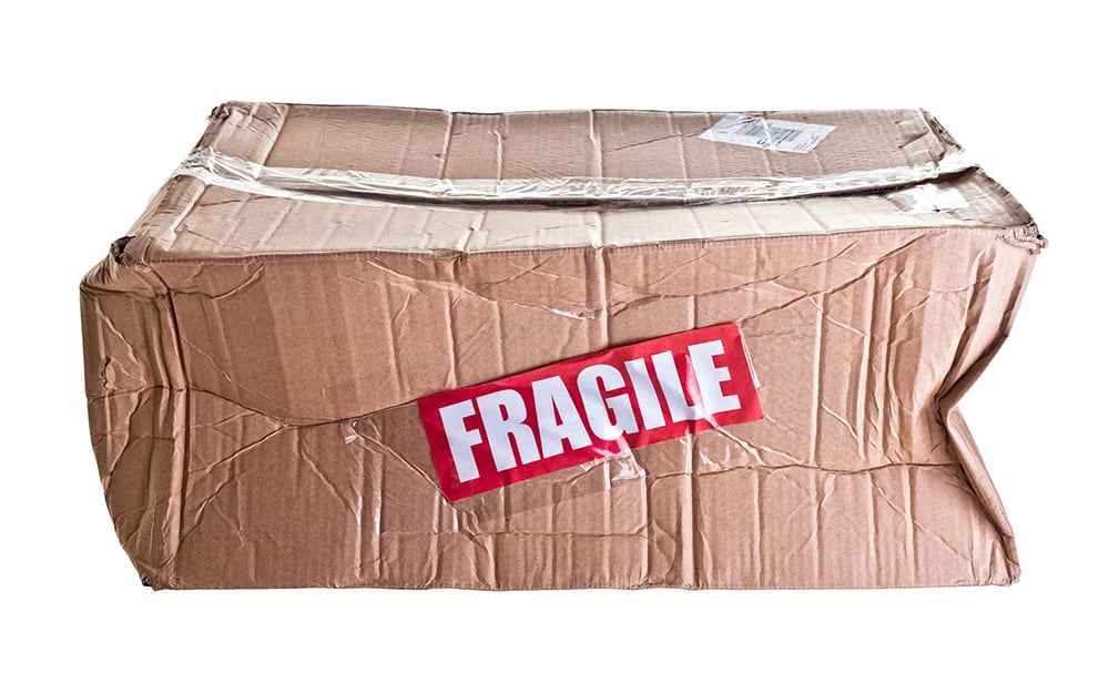 A dented box with the word fragile on it