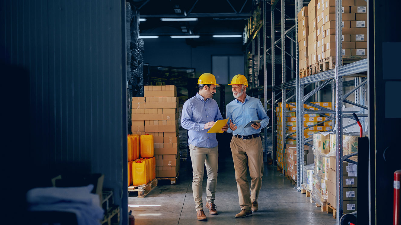 two warehouse workers walking