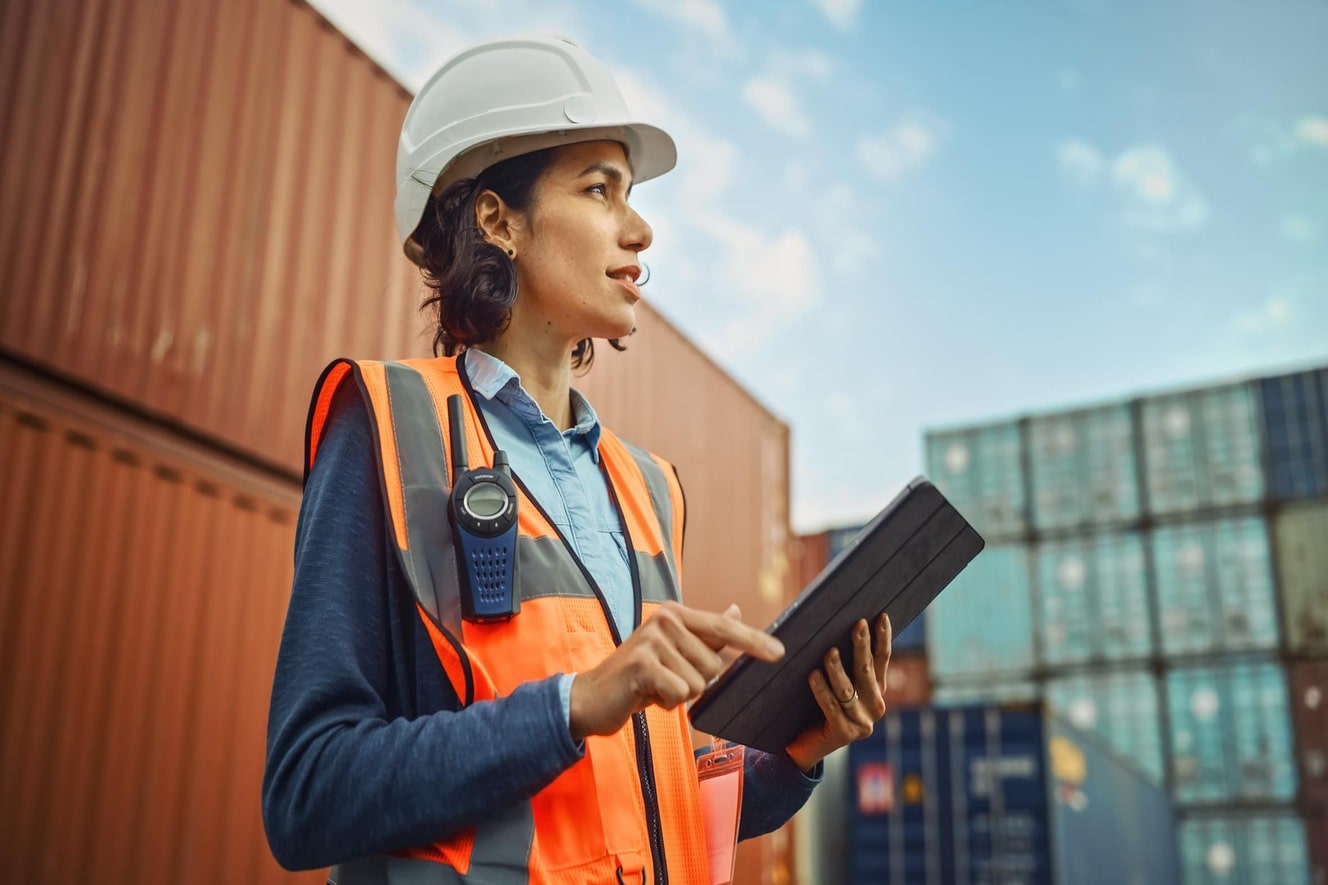 woman holding tablet wearing hard hat 