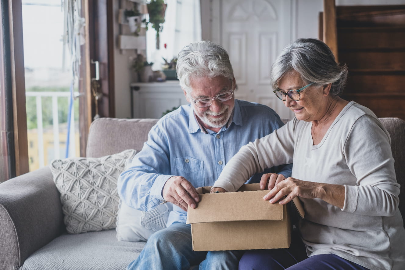 Elderly couple opening a package