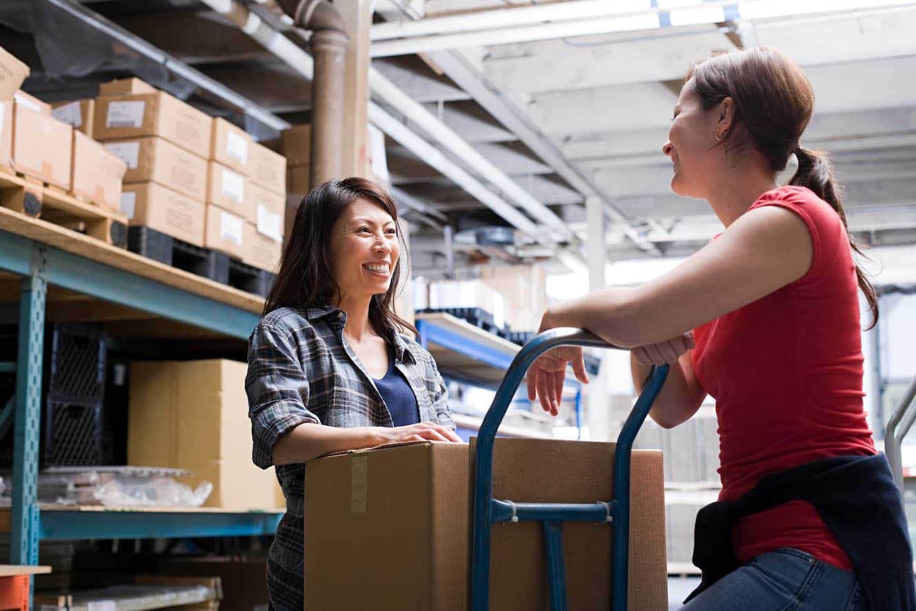 two women in warehouse talking