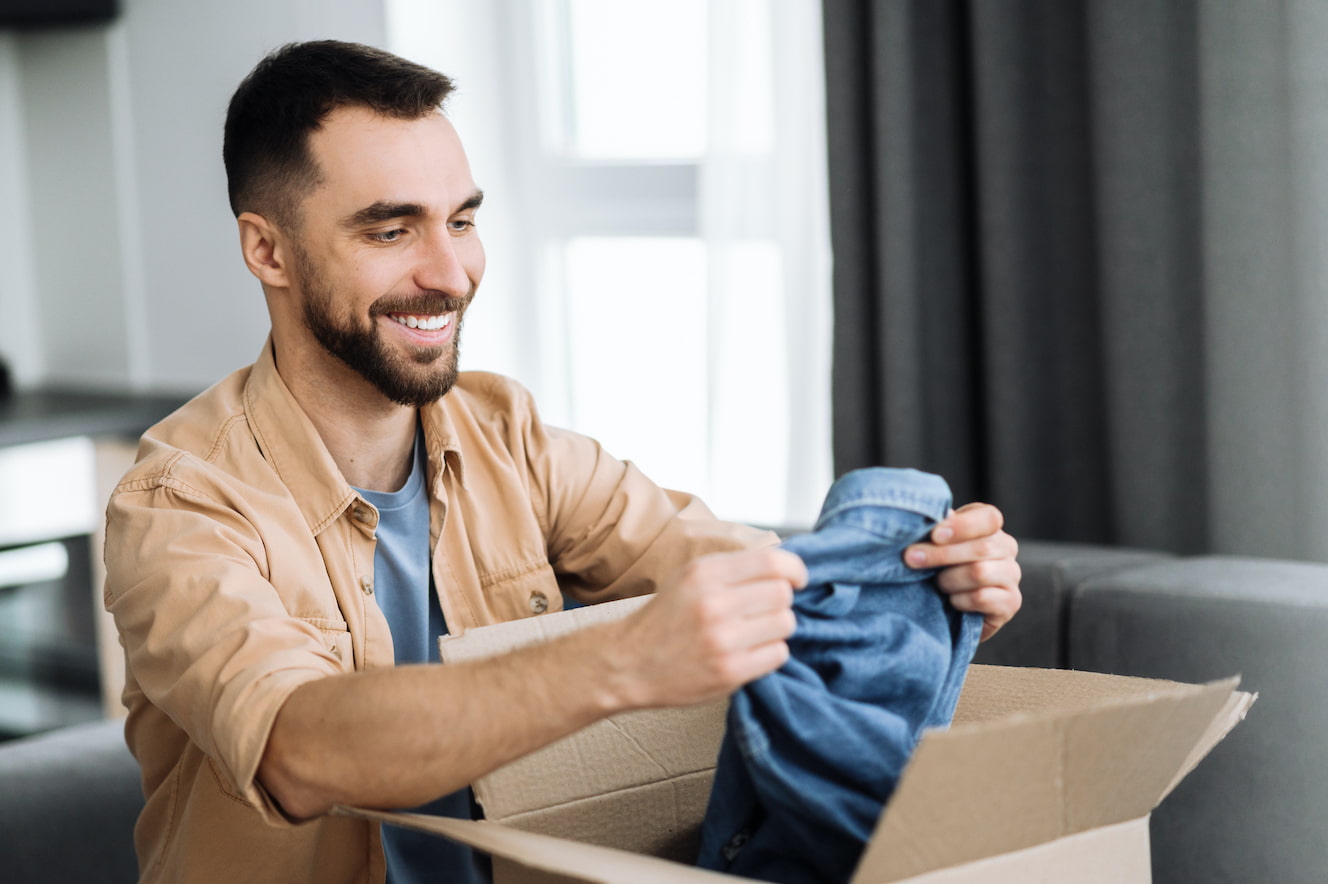 Man removing clothes from package