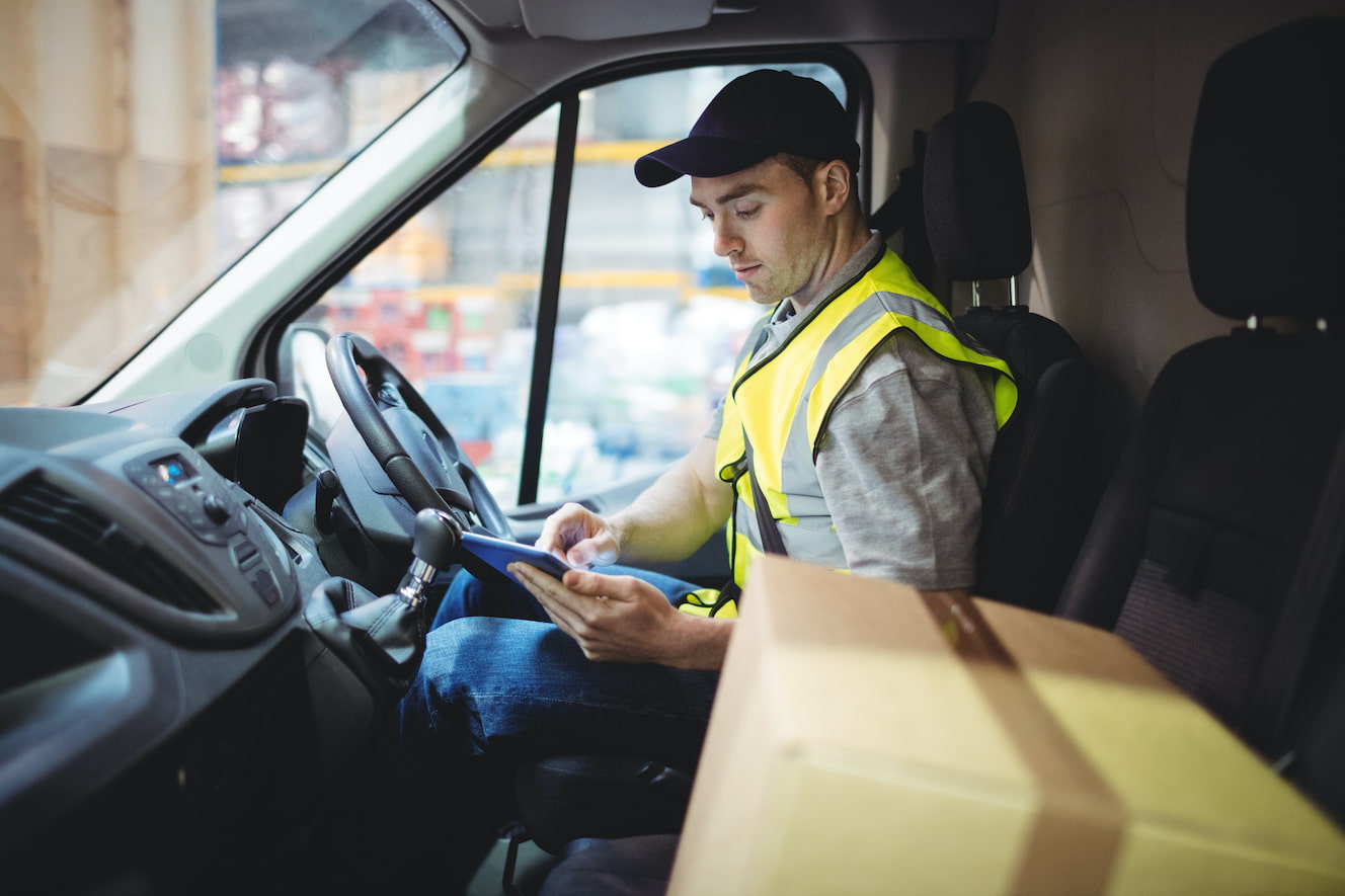 Delivery driver looking at tablet