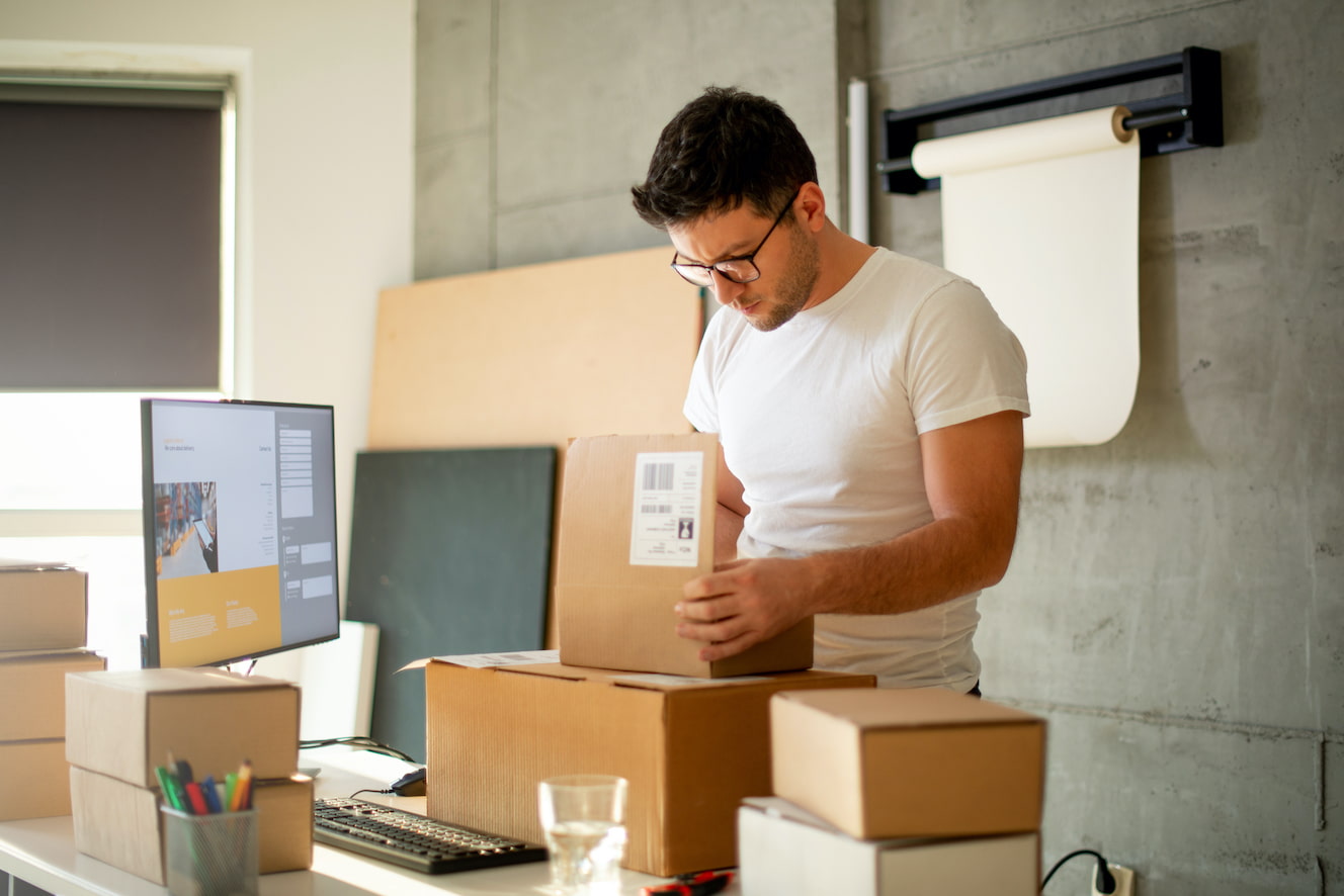 Man checking contents of shipping box