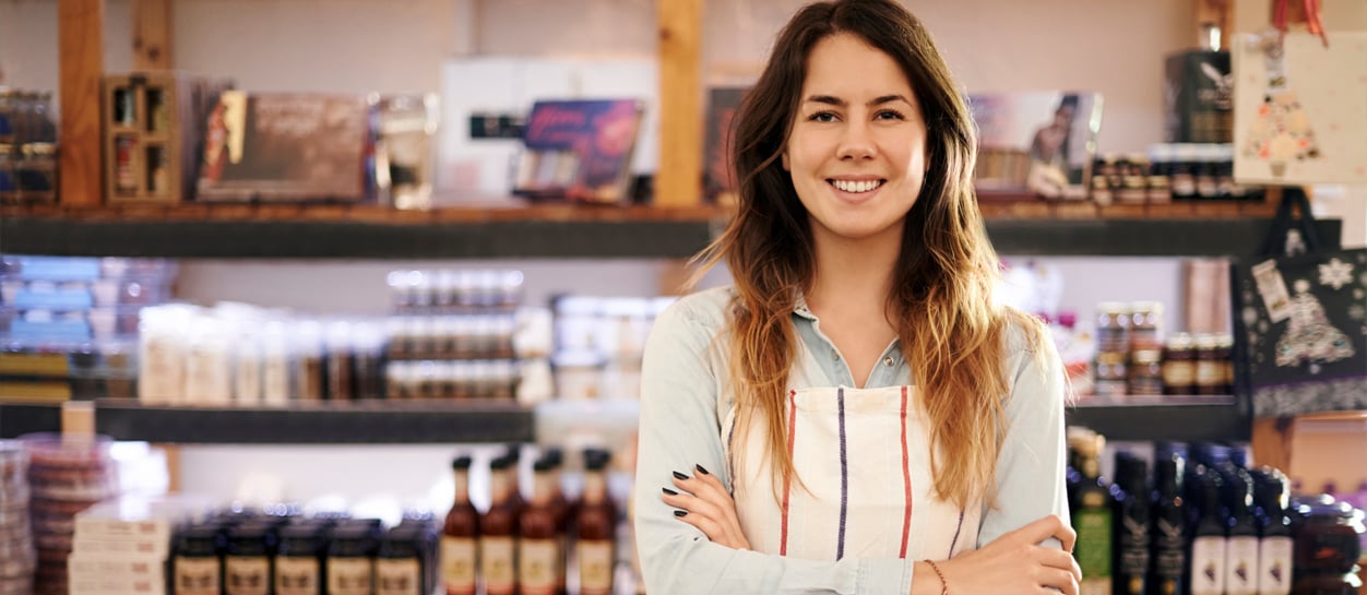 Small business owner standing in her store