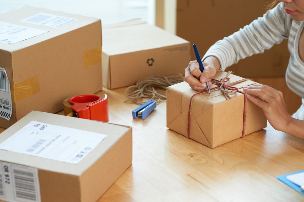 Person writing on package