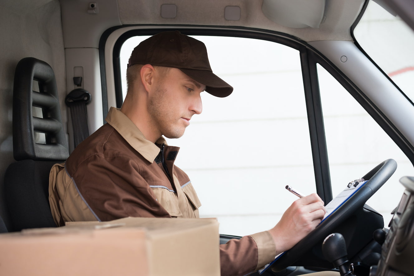 Delivery driver doing paperwork in their truck
