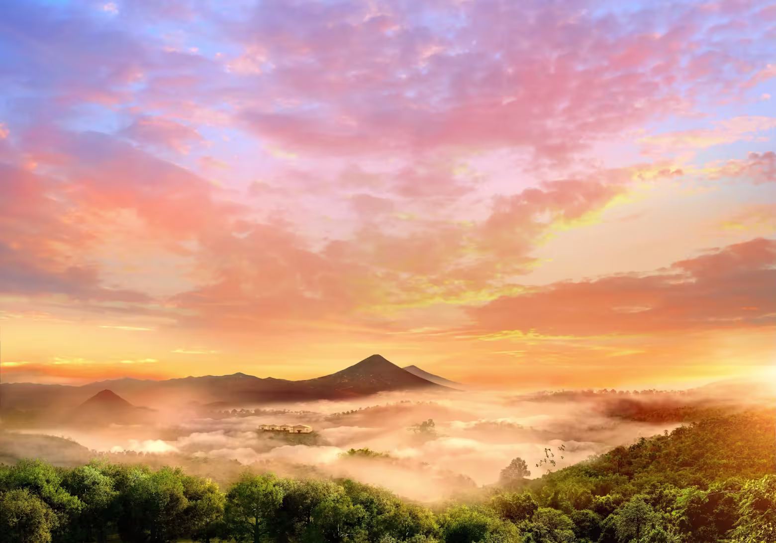 A breathtaking sunrise over lush green hills with misty clouds settling in the valleys.