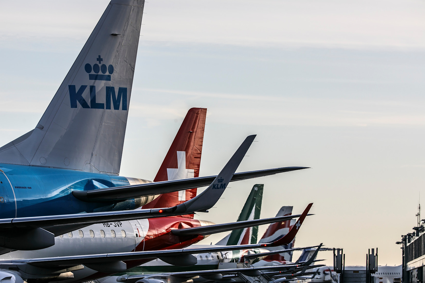 Tails of various planes on runway at LCY
