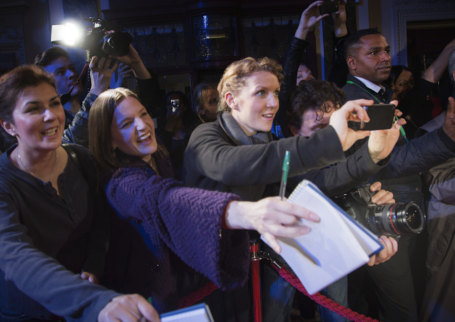 Fans reaching for autographs at red carpet event