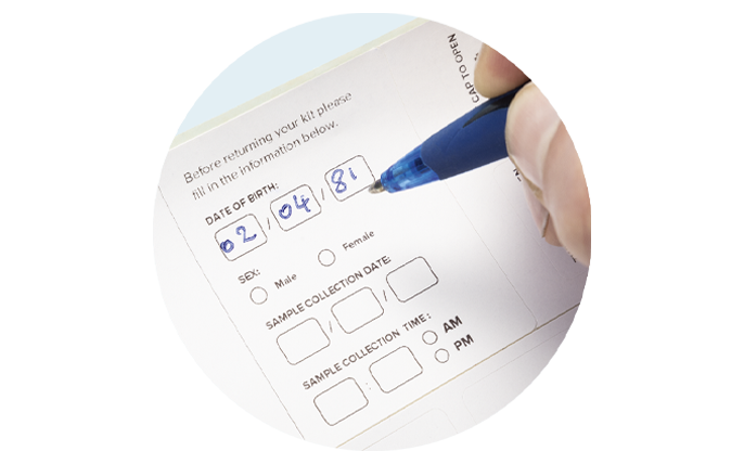 A pen filling in the date of birth, sex, sample collection date, and sample collection time on the bag label.