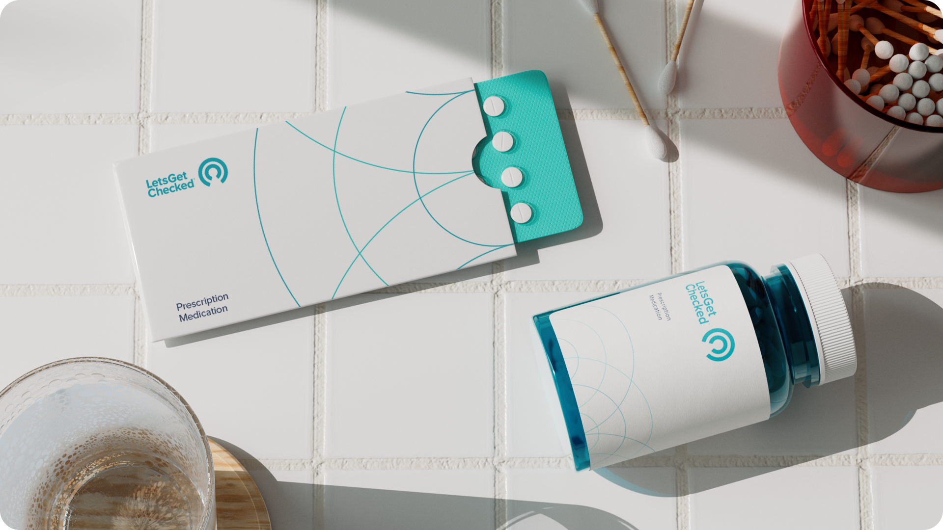 LetsGetChecked branded pack of tablets, and pill bottle on a tiled surface. LetsGetChecked branded pack of tablets, and pill bottle on a tiled surface.