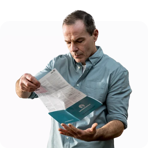 Older man reading the instructional pamphlet provided by the LetsGetChecked testing kit.