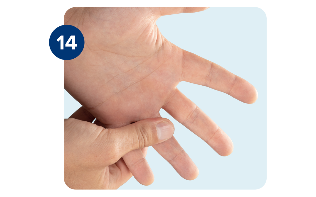 Right hand massaging left hand and base of the ring finger. Right hand massaging left hand and base of the ring finger.