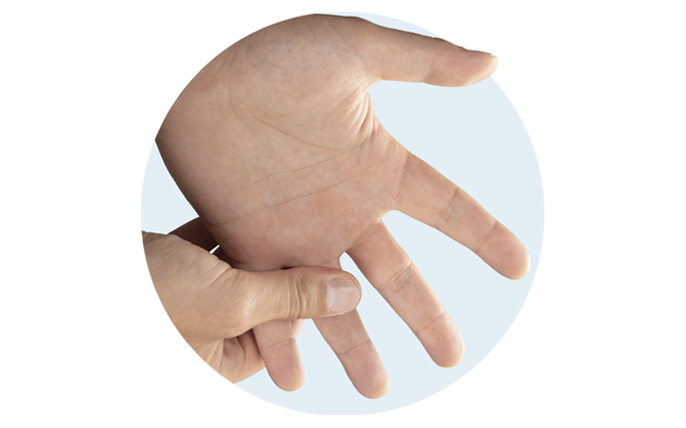 Right hand massaging left hand and base of the ring finger.