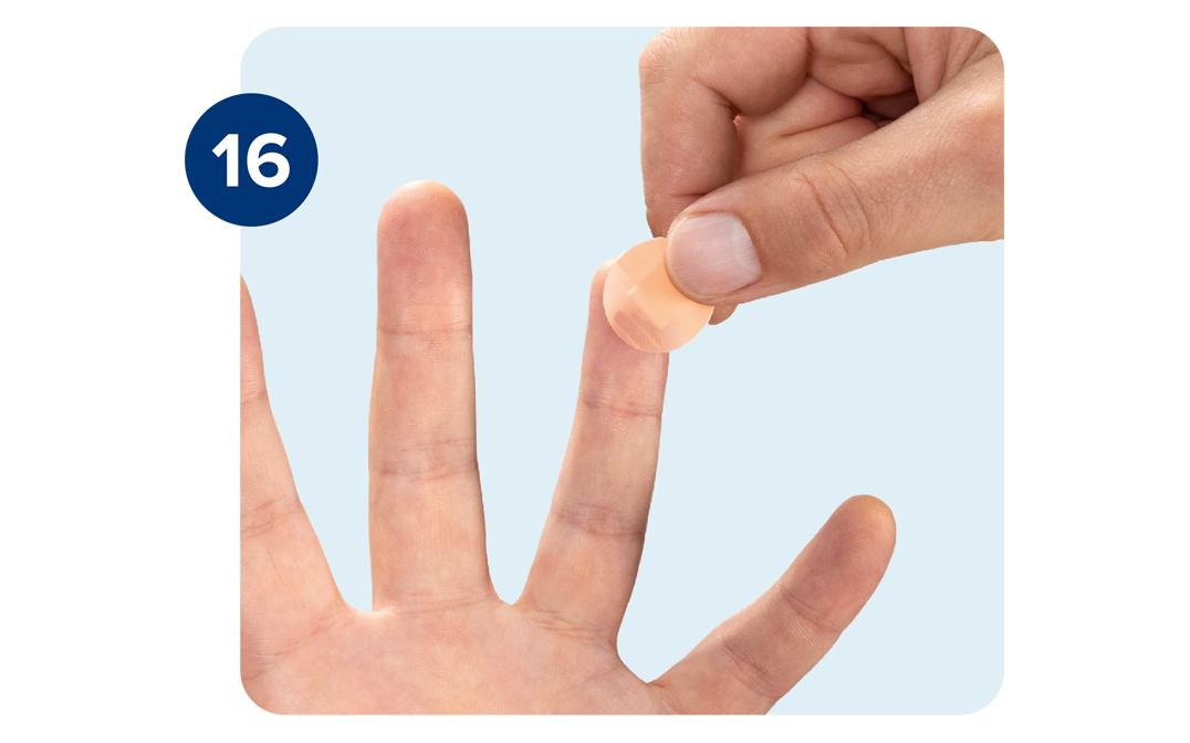 Right hand applying bandage to the tip of the ring finger on the left hand. Right hand applying bandage to the tip of the ring finger on the left hand.