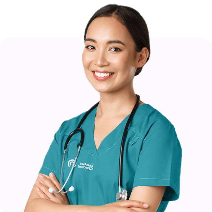 Healthcare provider smiling while wearing scrubs and a stethoscope.