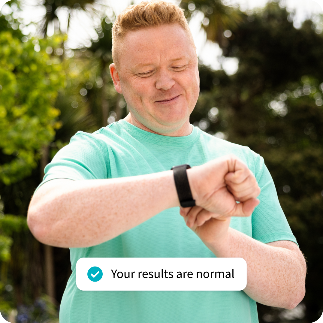 Man checking his smartwatch, next to a pop-up text that reads: "Your results are normal". Man checking his smartwatch, next to a pop-up text that reads: "Your results are normal".