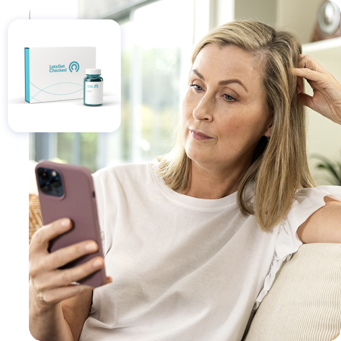 Woman using her smartphone to view a LetsGetcChecked testing kit.