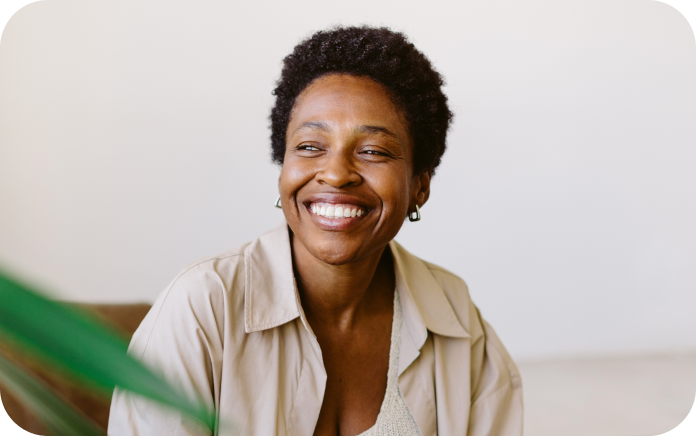 Smiling woman sitting on her sofa.
