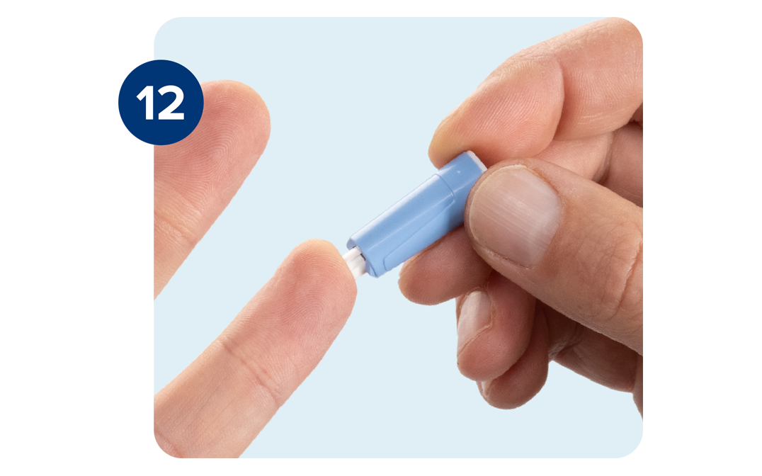 Right hand pressing lancet on the softer side of the tip of the ring finger of the left hand. Right hand pressing lancet on the softer side of the tip of the ring finger of the left hand.