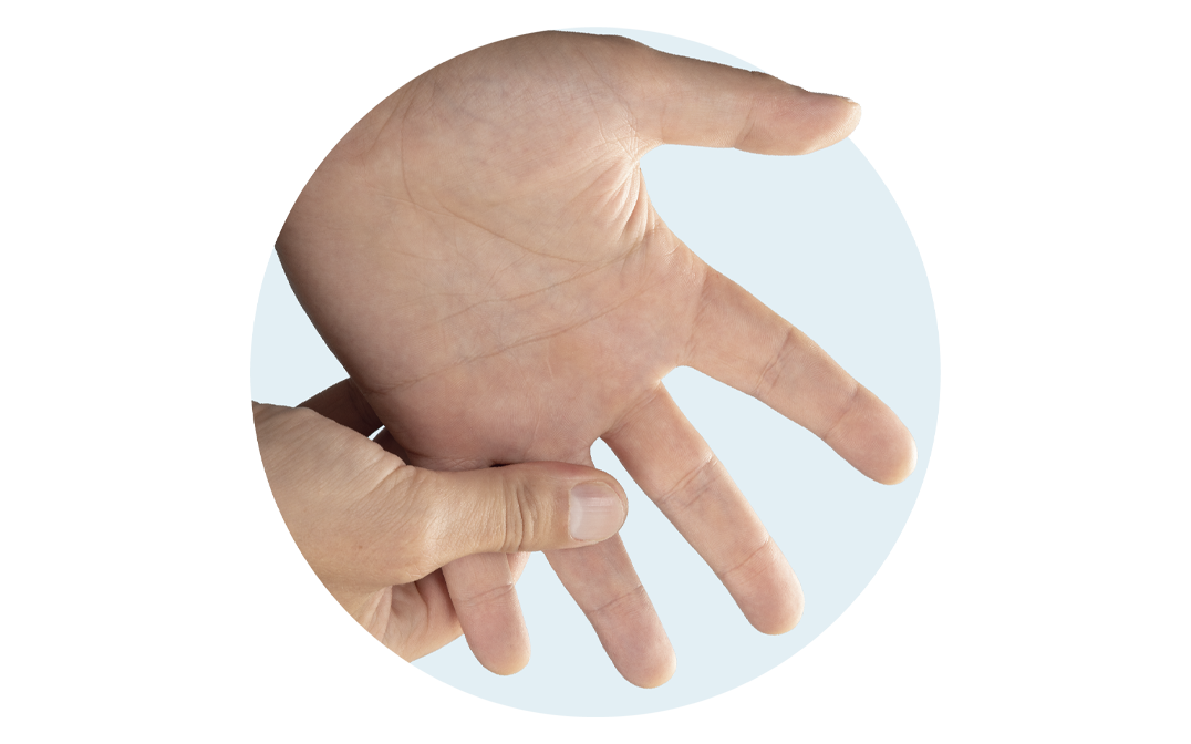 Right hand massaging left hand and base of the ring finger.