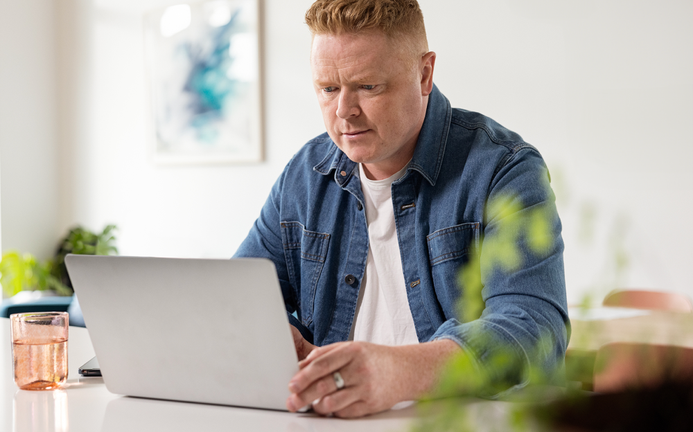 Man using his laptop to sign in to his LetsGetChecked account.