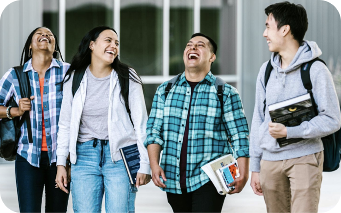 Group of four university students laughing.