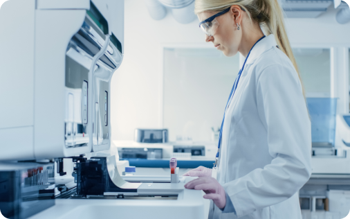 Scientist in a lab coat working with medical instruments.