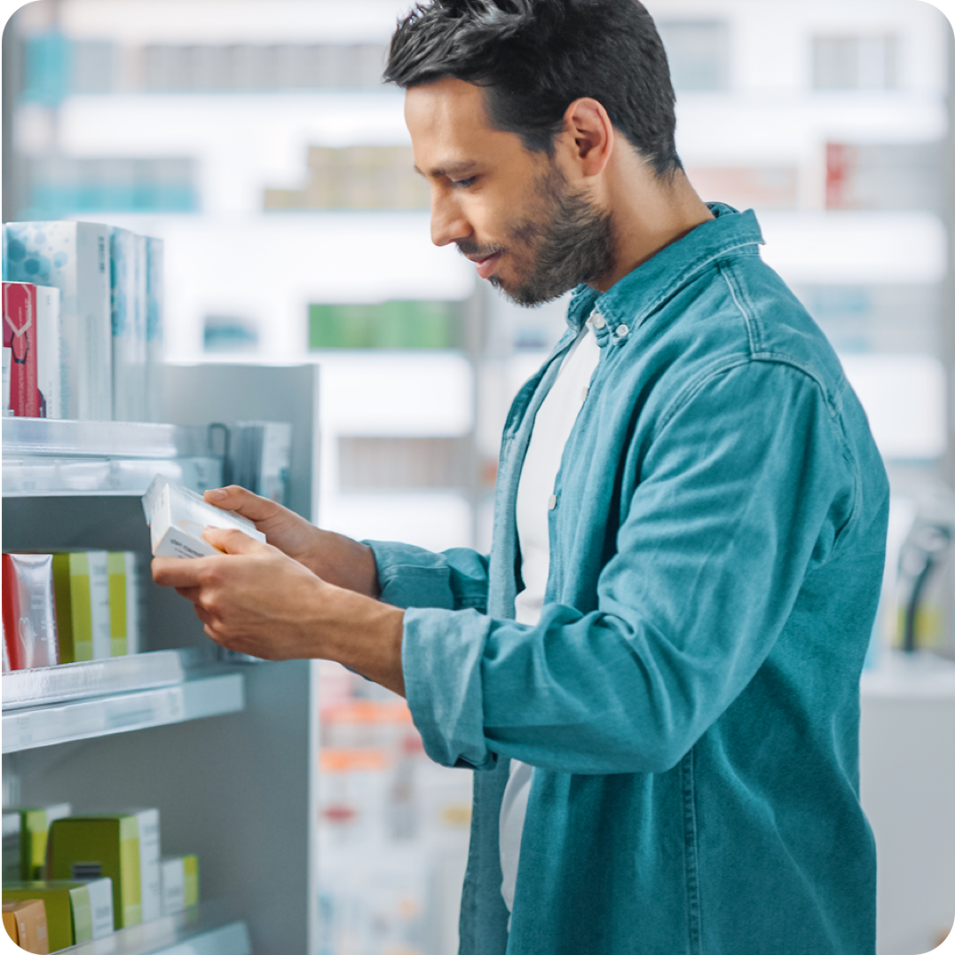 Man in pharmacy looking at supplements